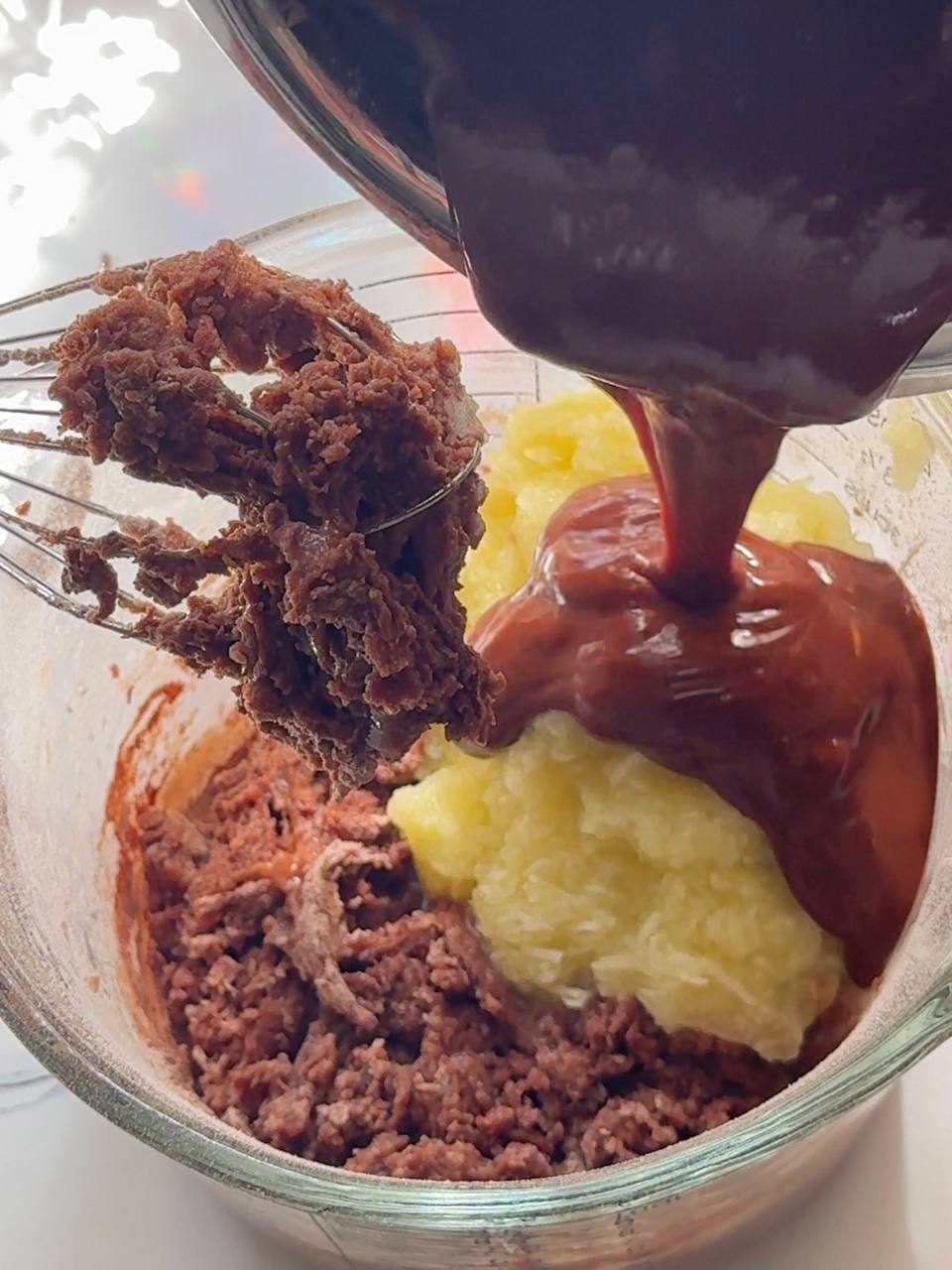 adding zucchini purée and melted chocolate mixture to the batter