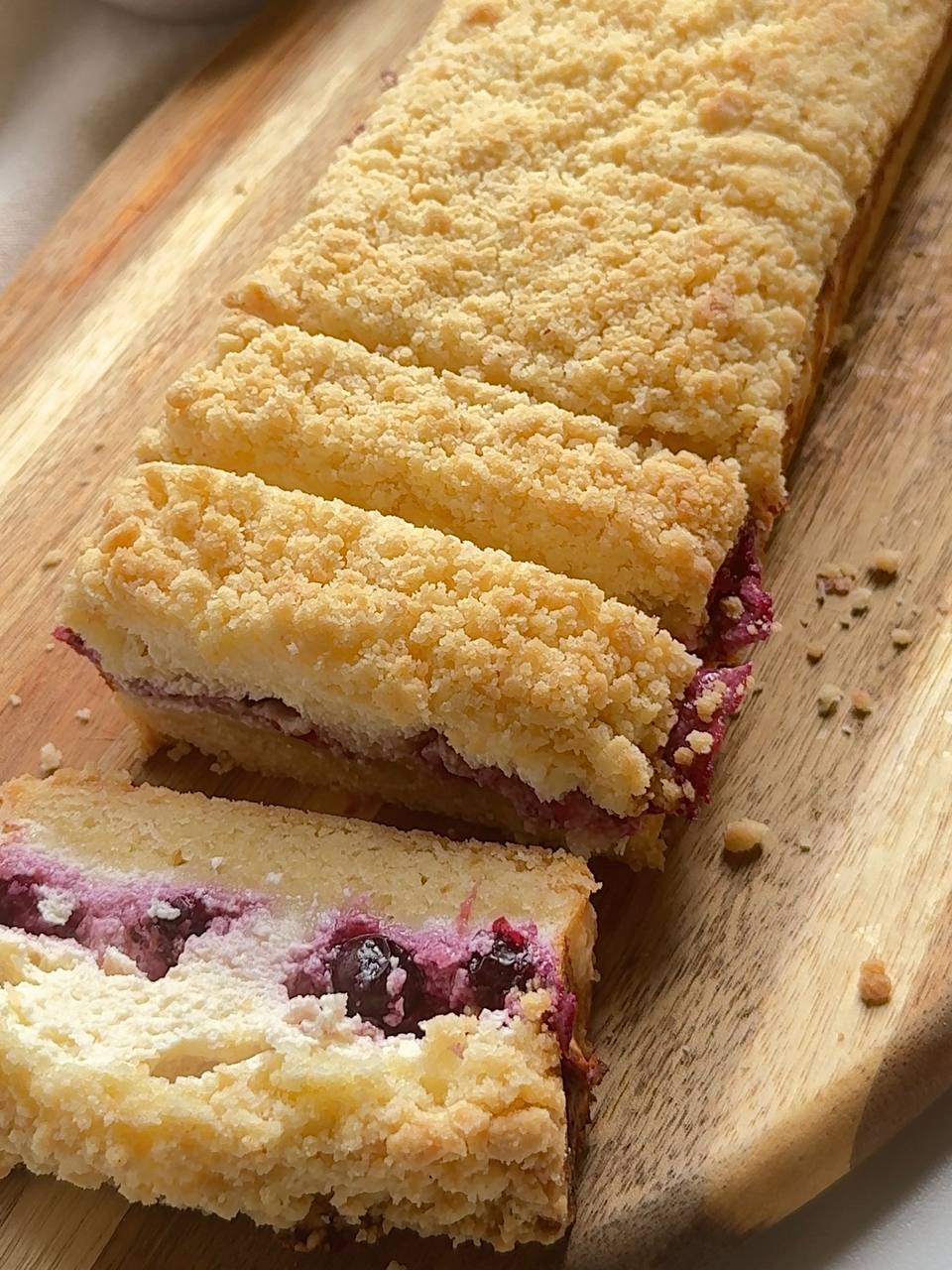 baked blackcurrant cottage cheese crumble cake sliced into squares