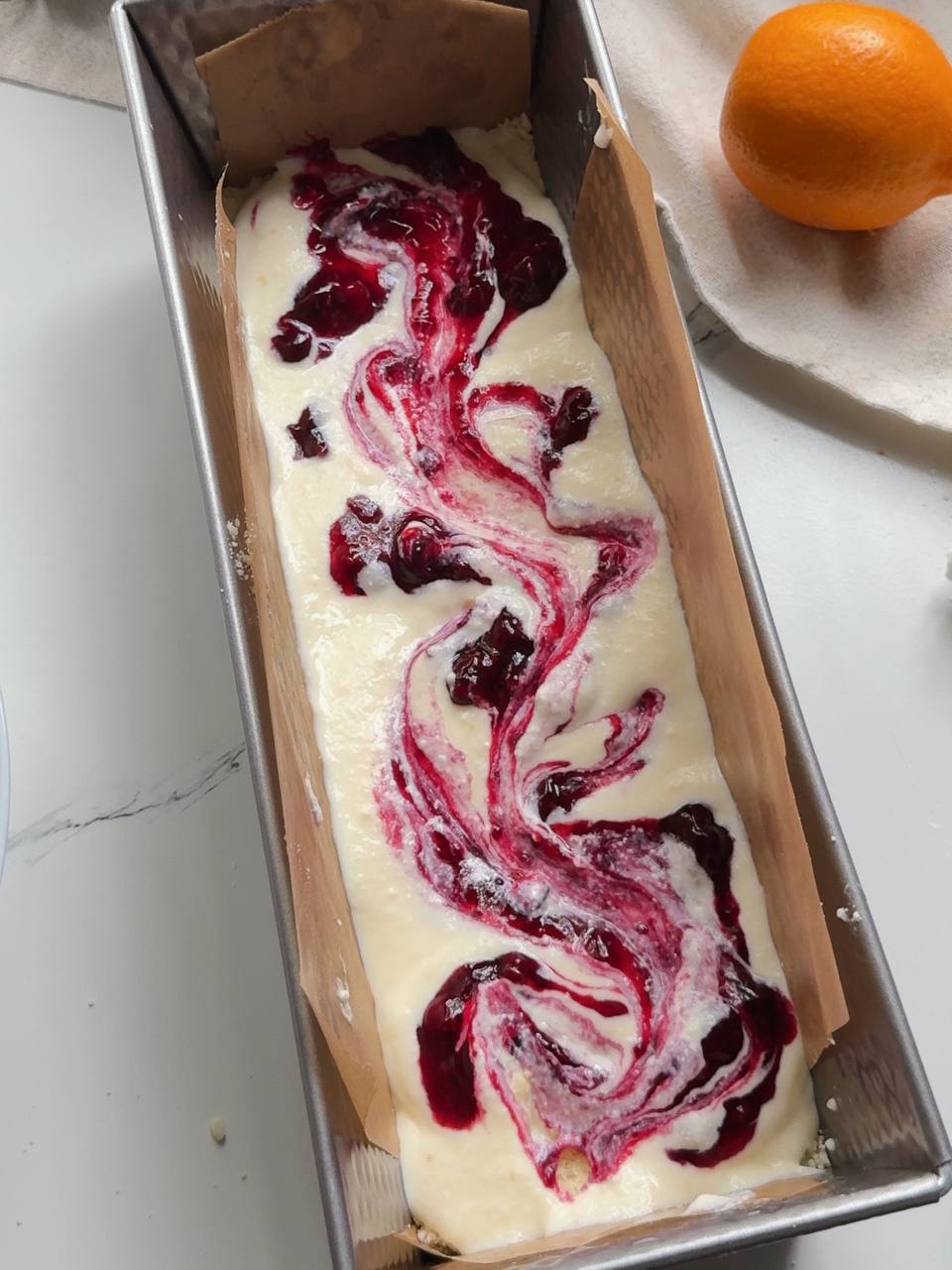swirling homemade blackcurrant jam into the cottage cheese filling