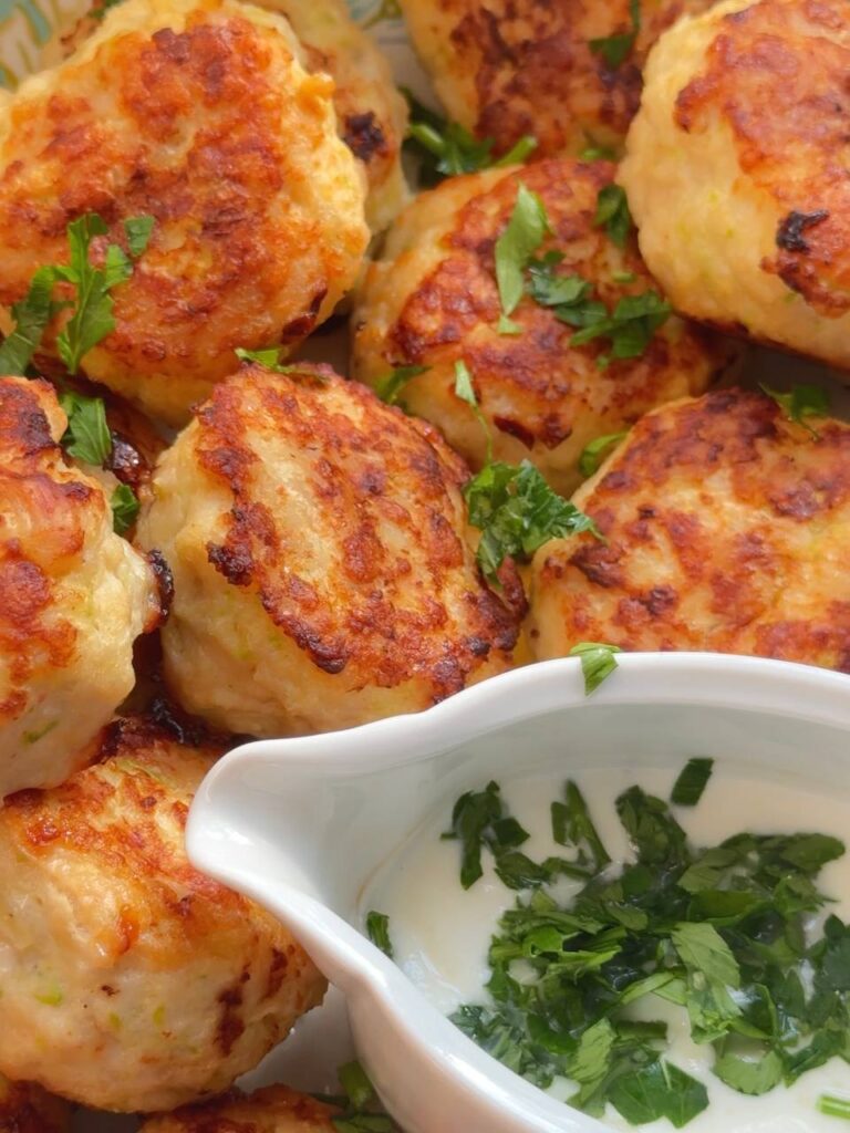 crispy chicken zucchini patties served with garlic yogurt sauce and parsley