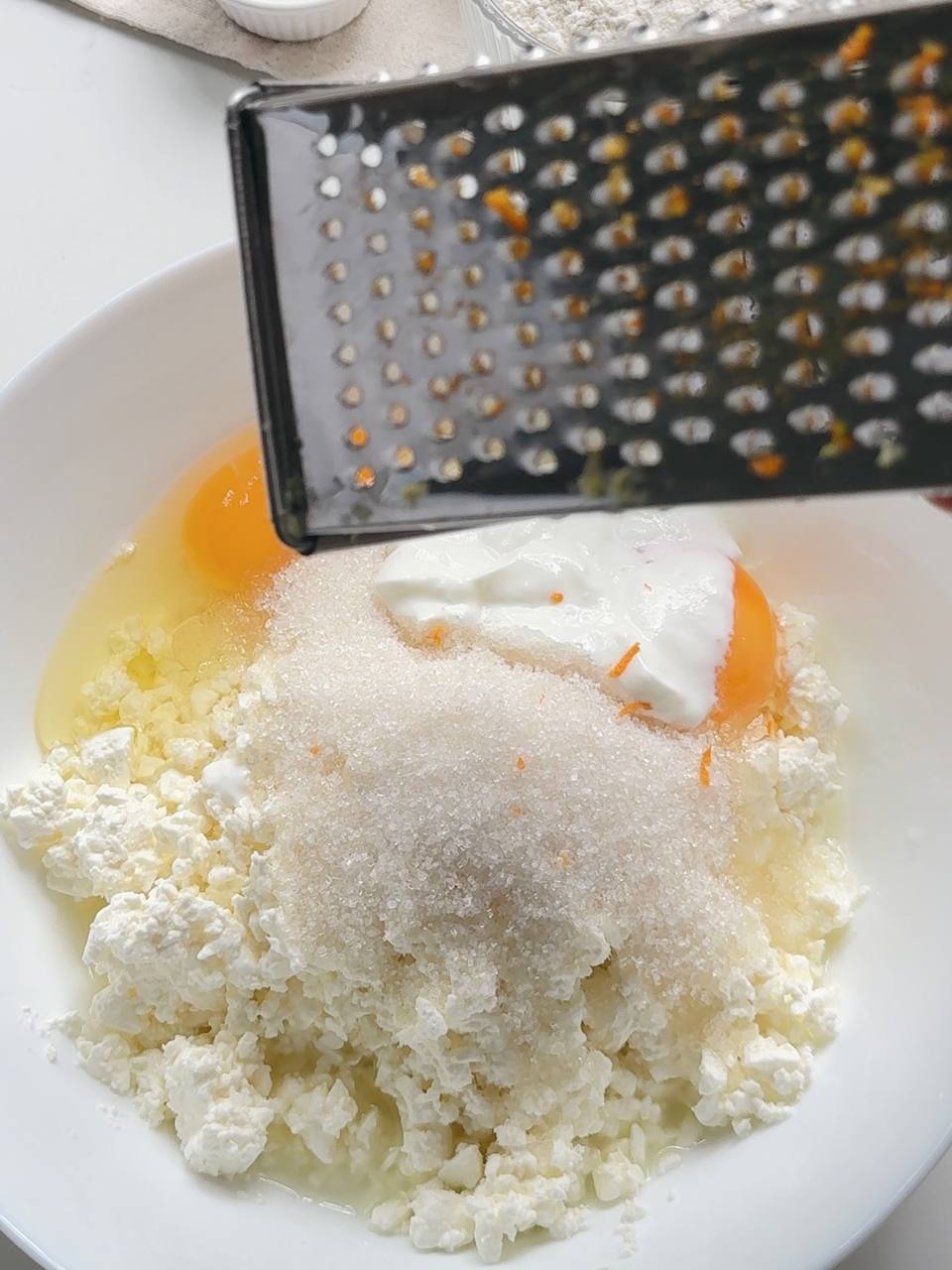 cottage cheese, eggs, sugar, sour cream, and lemon zest in a mixing bowl