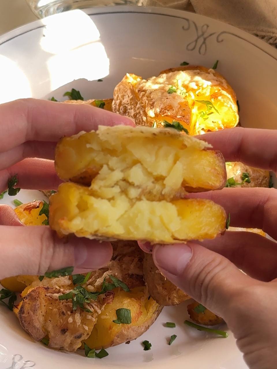 close-up of a crispy smashed potato with a fluffy center