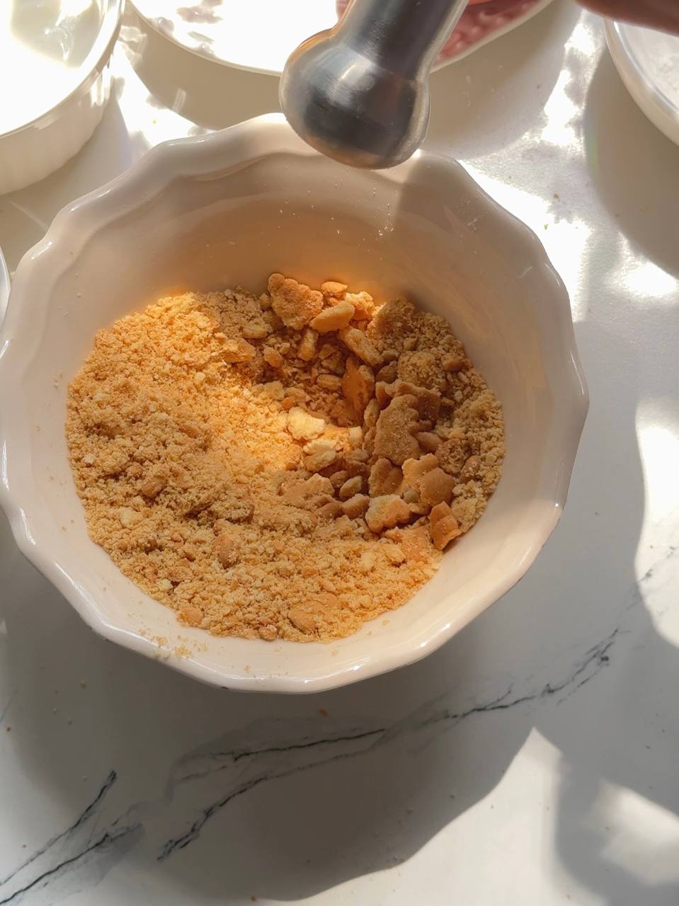 crushing butter cookies into fine crumbs