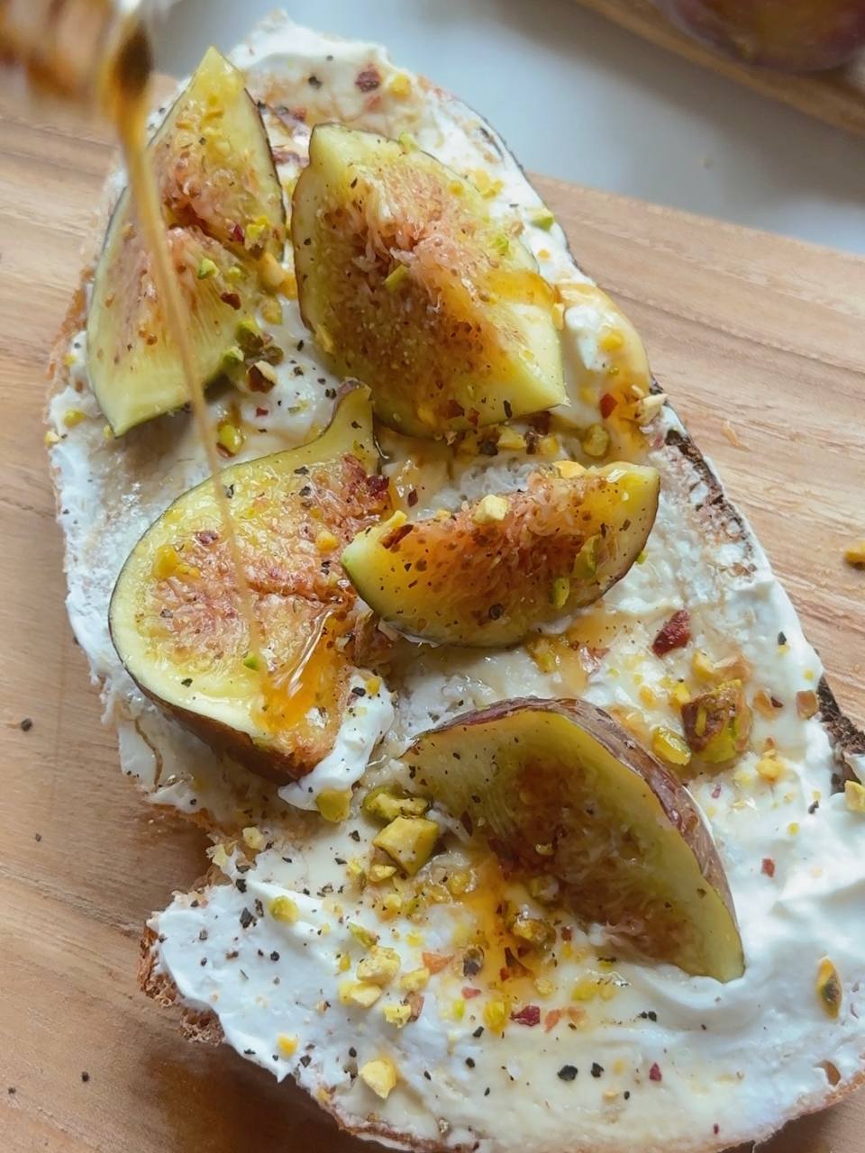 drizzling maple syrup over fig cottage cheese toast
