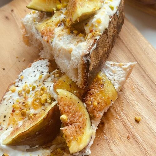 fig cottage cheese toast with pistachios and maple syrup served for breakfast