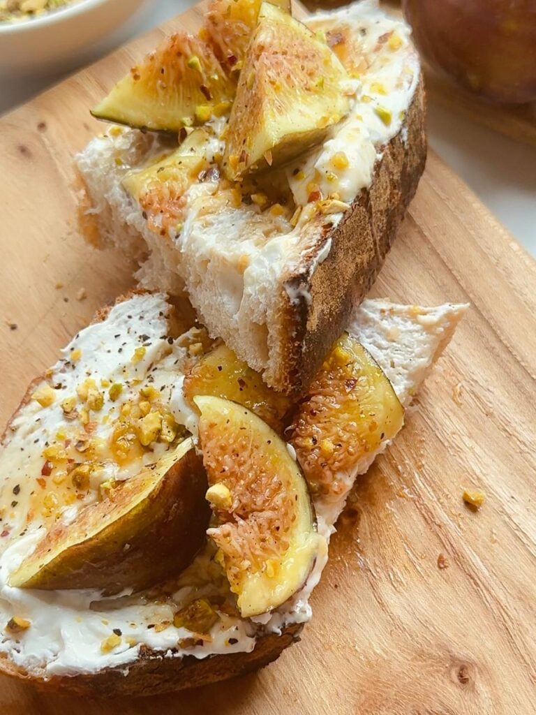 fig cottage cheese toast with pistachios and maple syrup served for breakfast