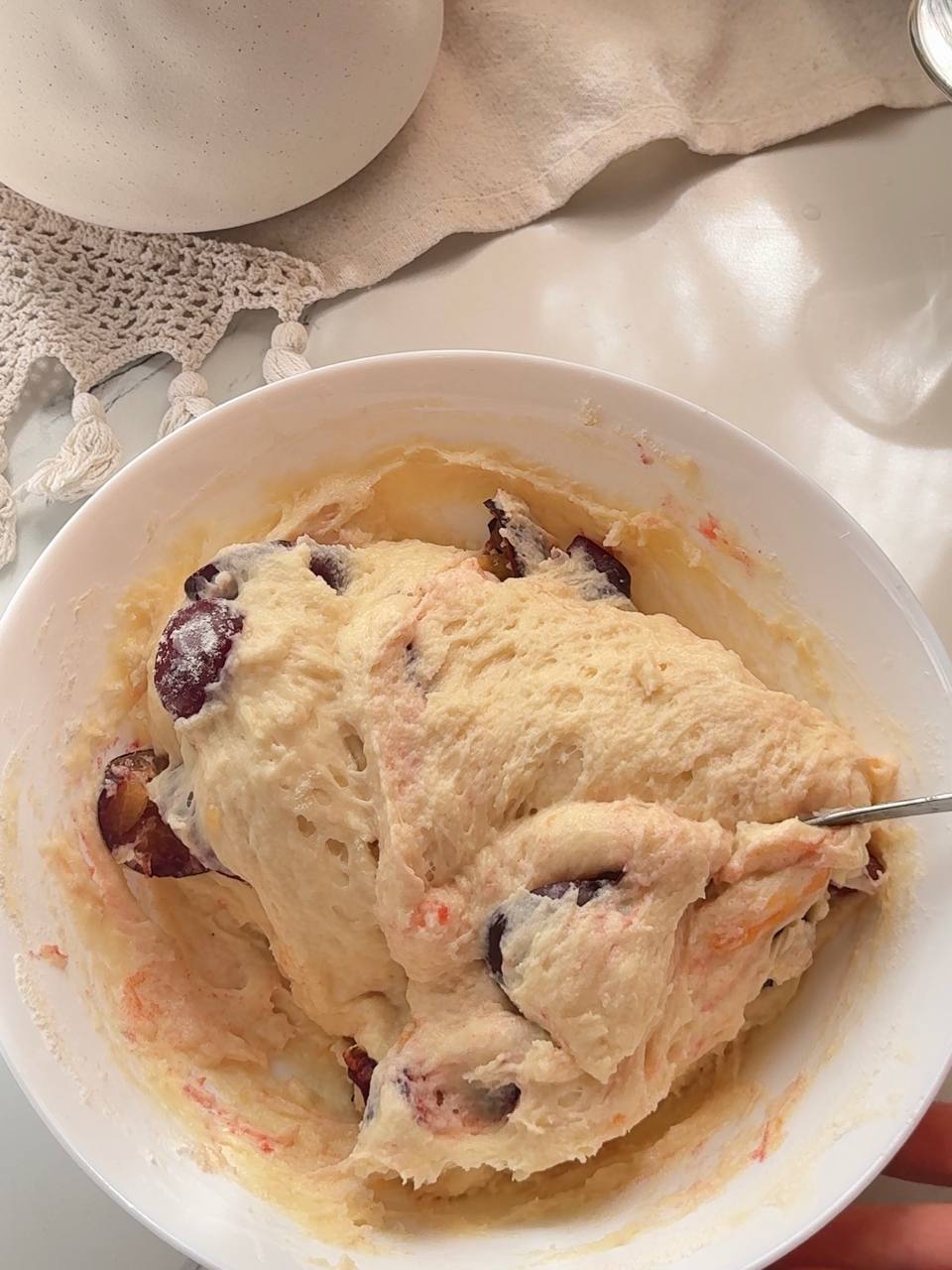 Folding fresh plums into the cake batte