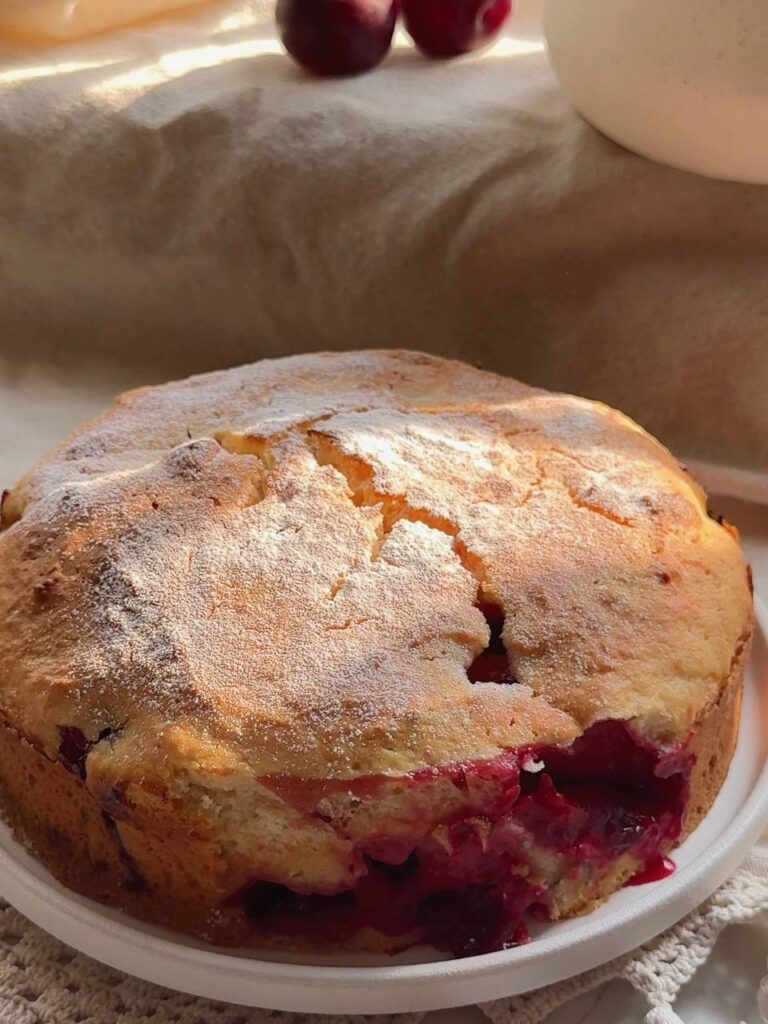 Whole Greek yogurt plum cake dusted with powdered sugar