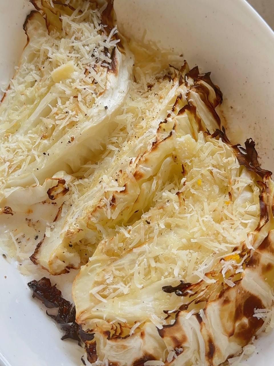 roasted cabbage steaks topped with grated Parmesan before baking