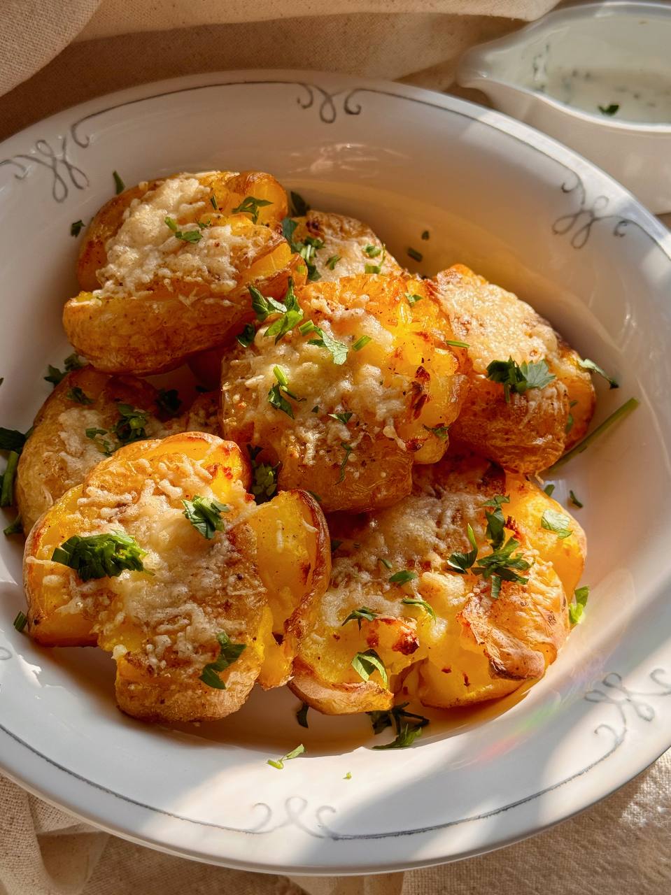 crispy smashed potatoes served with garlic yogurt sauce and fresh parsley