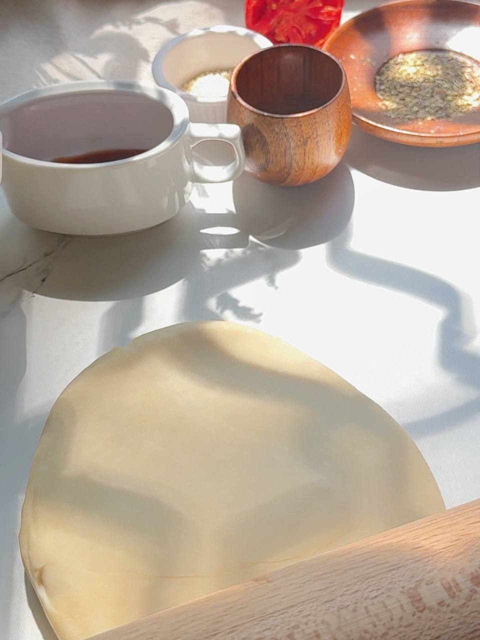 rolling out puff pastry into a circle