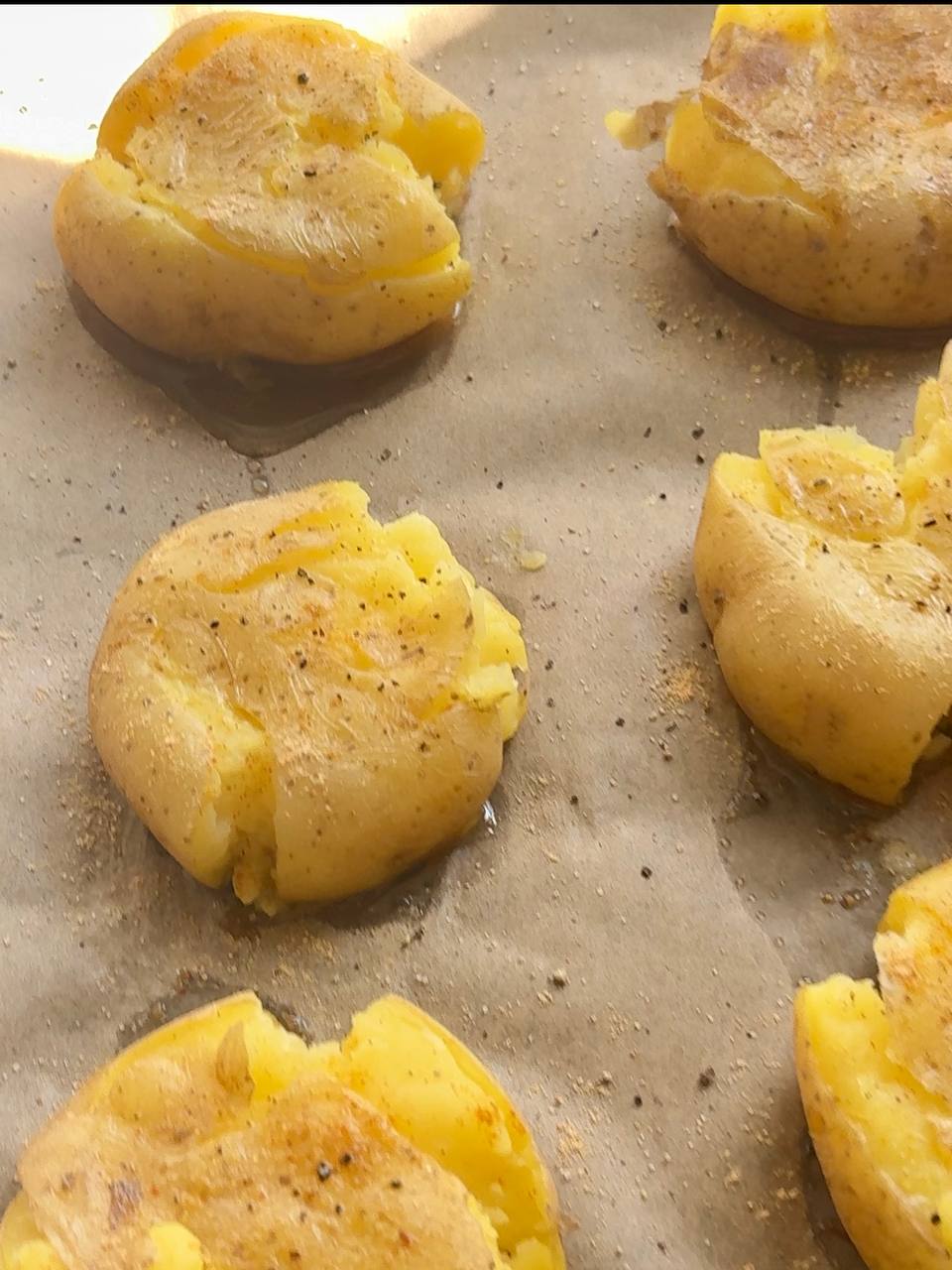 drizzling olive oil and seasoning the smashed potatoes