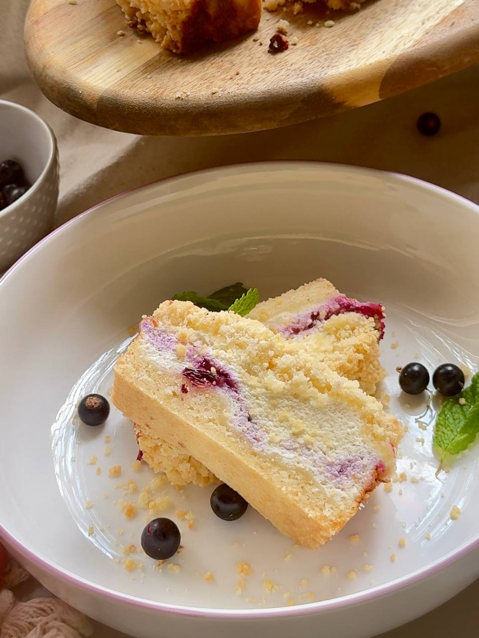 blackcurrant cottage cheese crumble cake served with fresh blackcurrants and mint