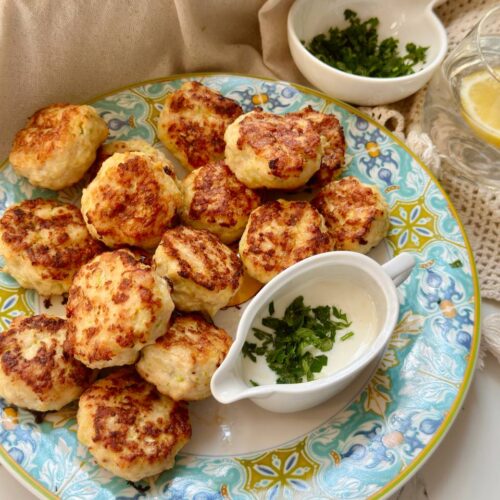served chicken zucchini patties with garlic sauce and fresh parsley