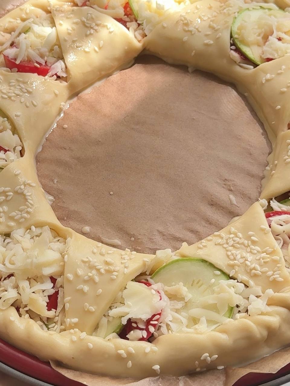 zucchini puff pastry tart brushed with egg wash and sprinkled with sesame seeds