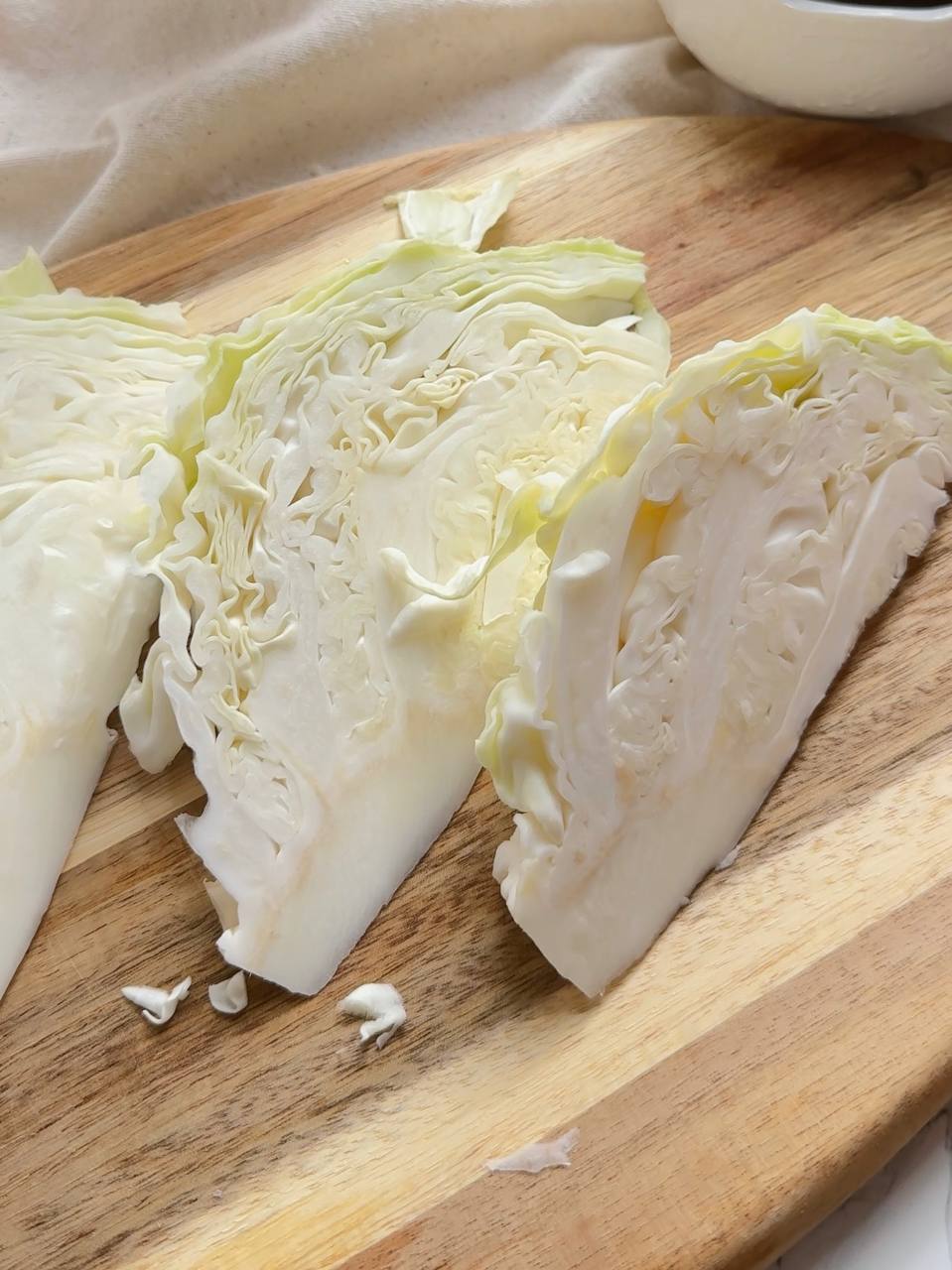 young cabbage cut into thick steaks with the core intact