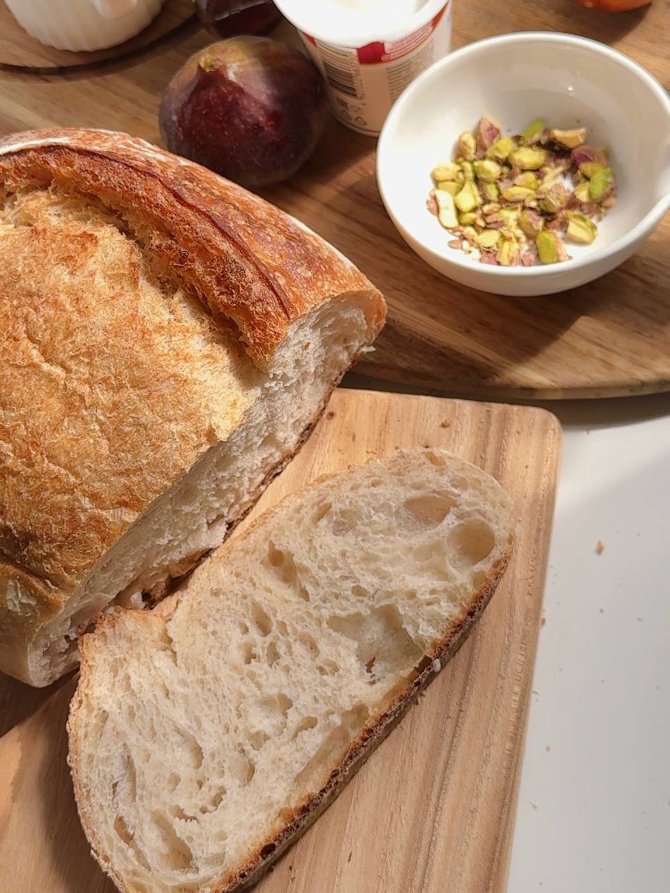 slicing sourdough bread for fig cottage cheese toast