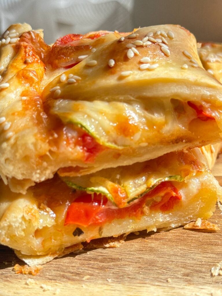 close-up of a zucchini puff pastry ring tart with mozzarella