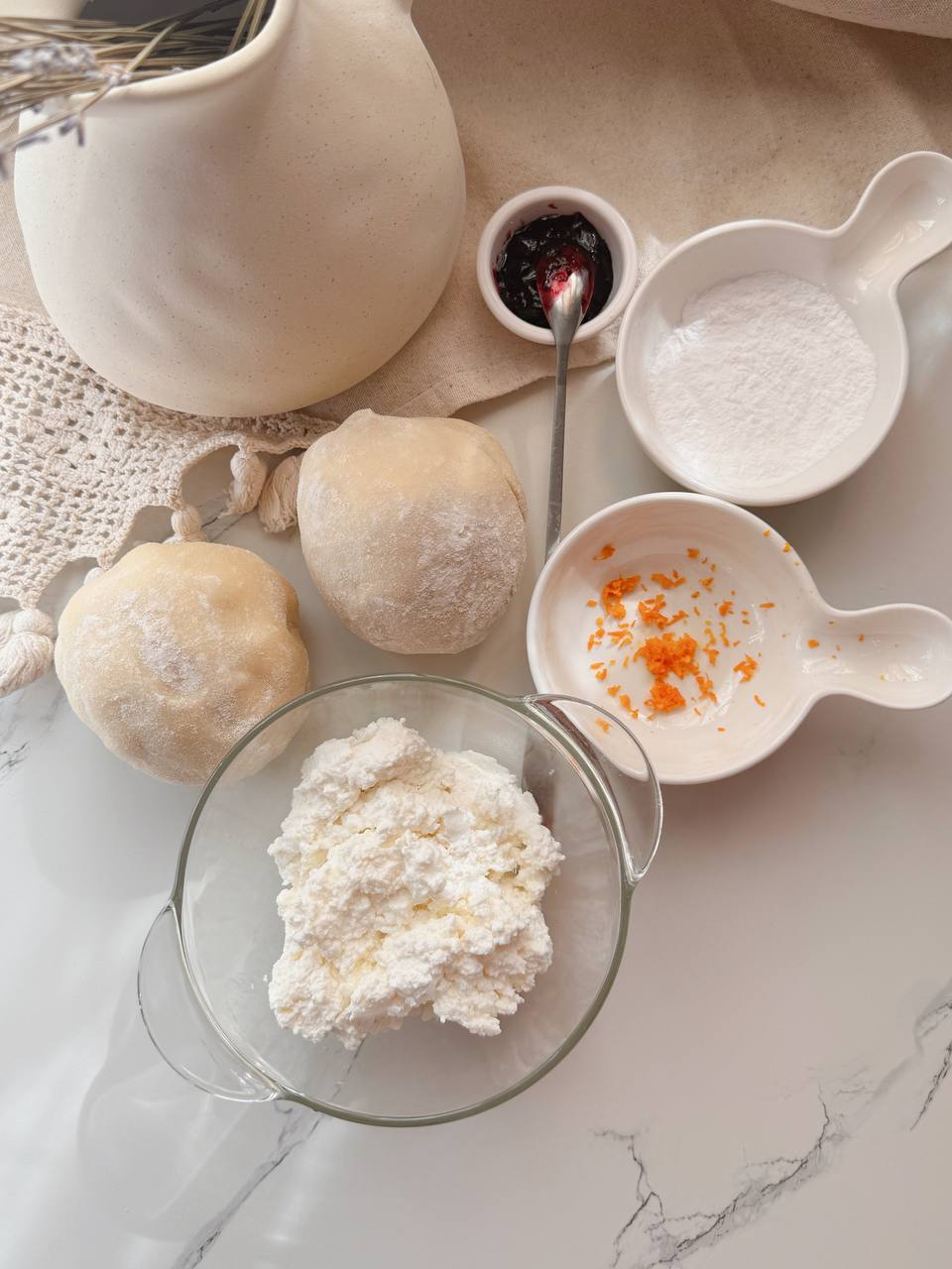Ingredients for cottage cheese buns with blackcurrant jam and lemon zest
