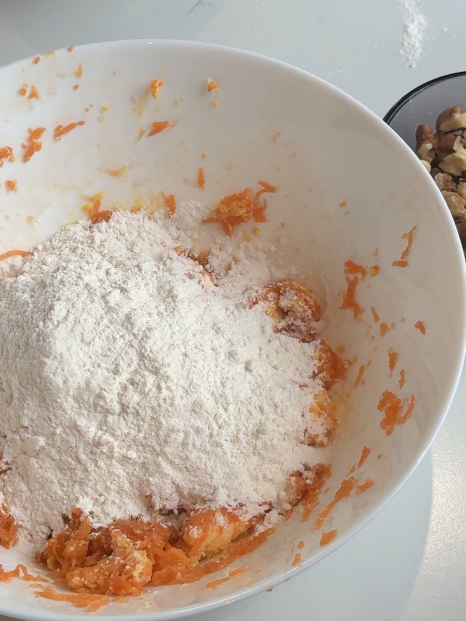 All-purpose flour added to the carrot mixture to make carrot cake cookie dough