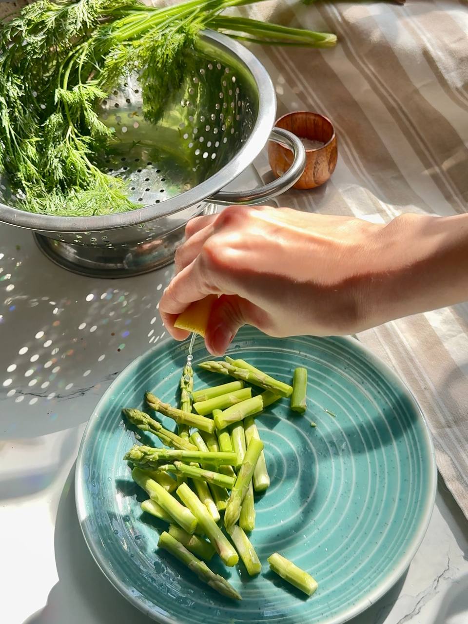 Fresh asparagus seasoned with lemon before adding to the baked salmon