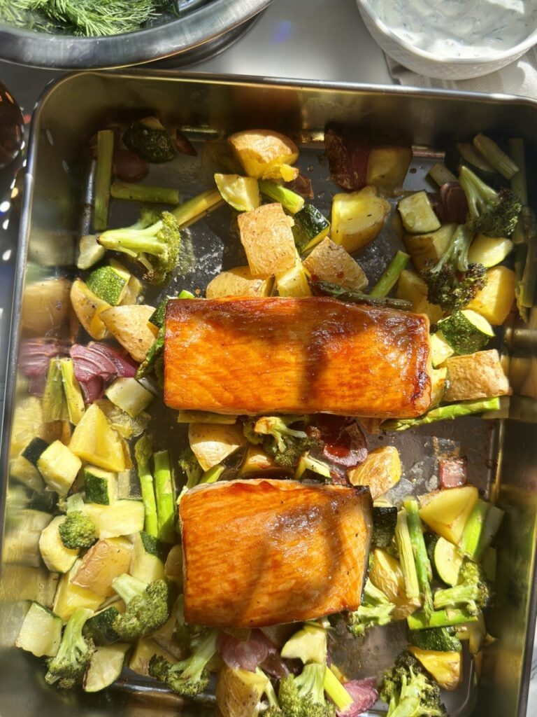 Baked salmon with roasted potatoes, broccoli, zucchini, asparagus and red onion