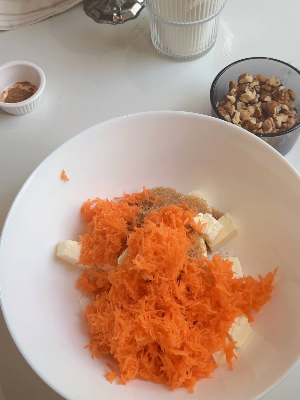 Finely grated carrot added to softened butter and brown sugar for carrot cake cookies