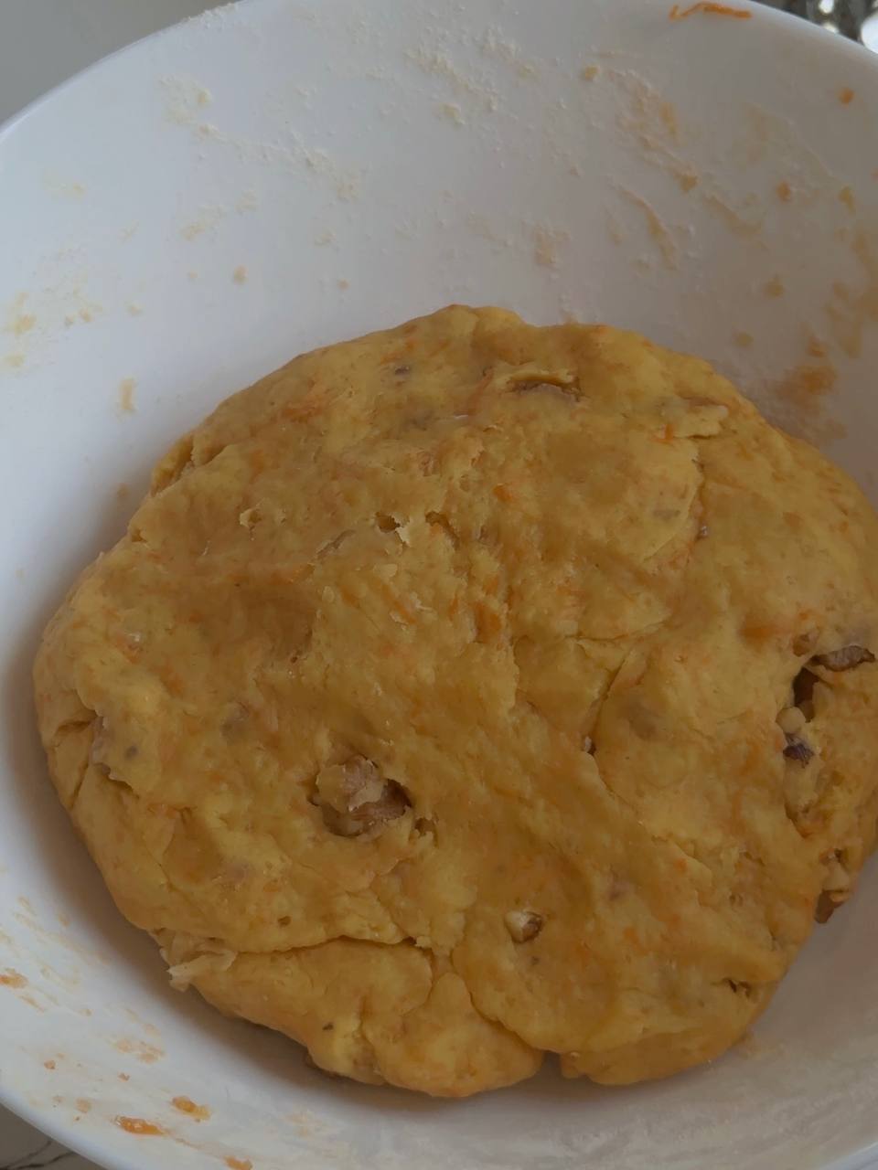 Finished carrot cake cookie dough with fresh grated carrot and walnuts