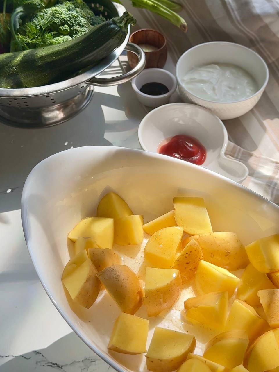 Chopped potatoes prepared for baked salmon with roasted vegetables