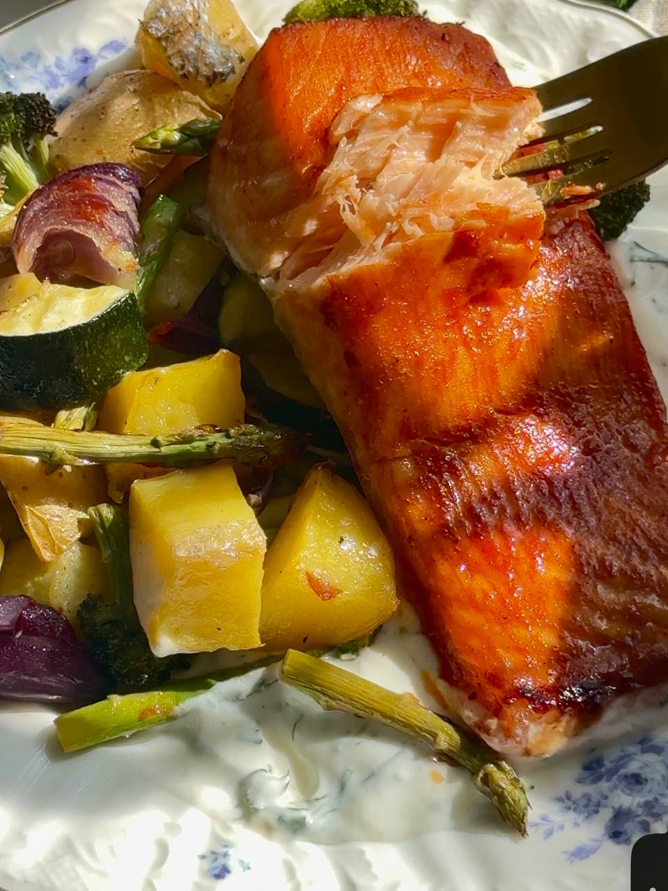 Flaky baked salmon with roasted vegetables and creamy dill sauce
