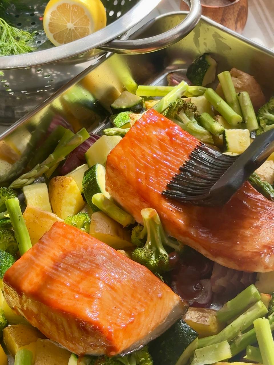 Baked salmon brushed with the remaining glaze alongside roasted vegetables and asparagus