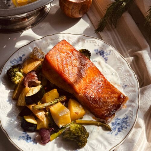 Salmon and dill sauce with roasted potatoes, broccoli, zucchini and asparagus