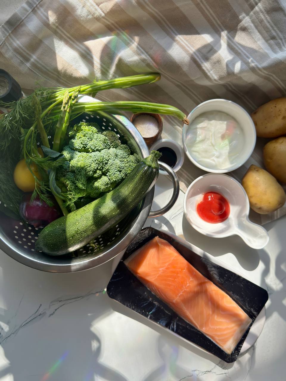 Ingredients for salmon and dill sauce with fresh salmon, Greek yogurt, potatoes, broccoli, zucchini and asparagus