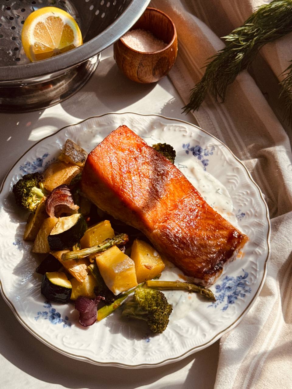 Salmon and dill sauce with roasted potatoes, broccoli, zucchini and asparagus