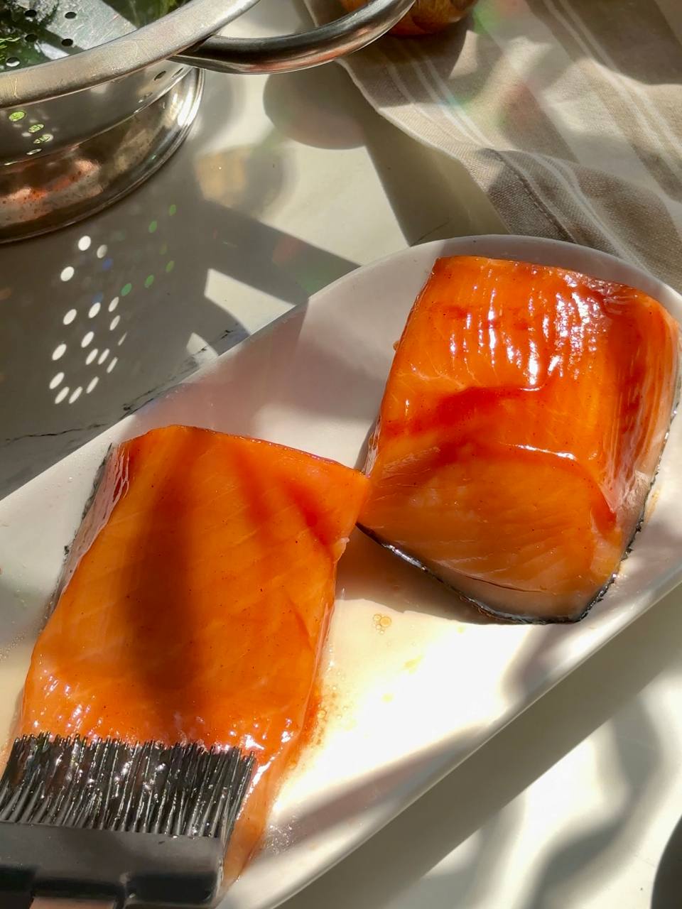 Salmon fillets brushed with a simple soy sauce and ketchup glaze before baking