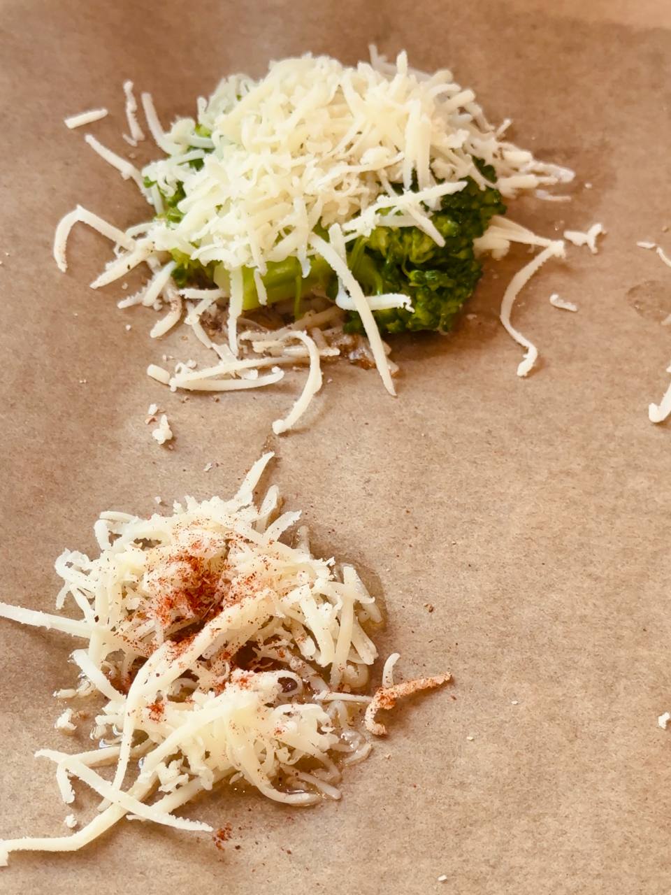 Olive oil, grated Parmesan, and seasonings arranged on a parchment-lined baking sheet.