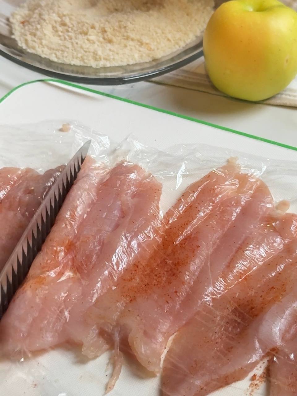 Thin chicken breast pieces seasoned with spices and gently pounded to an even thickness before breading.